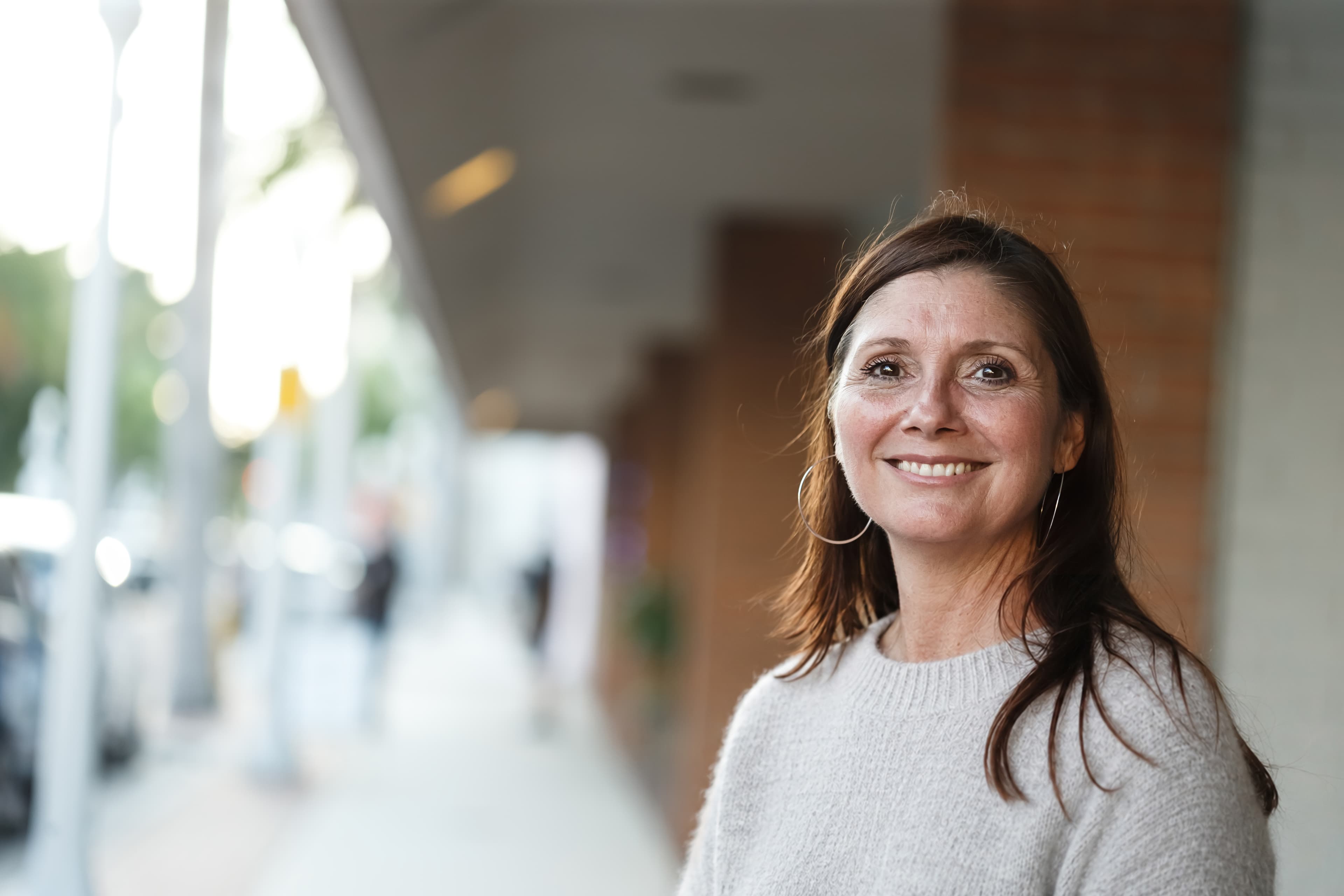A woman smiling in a bright community space