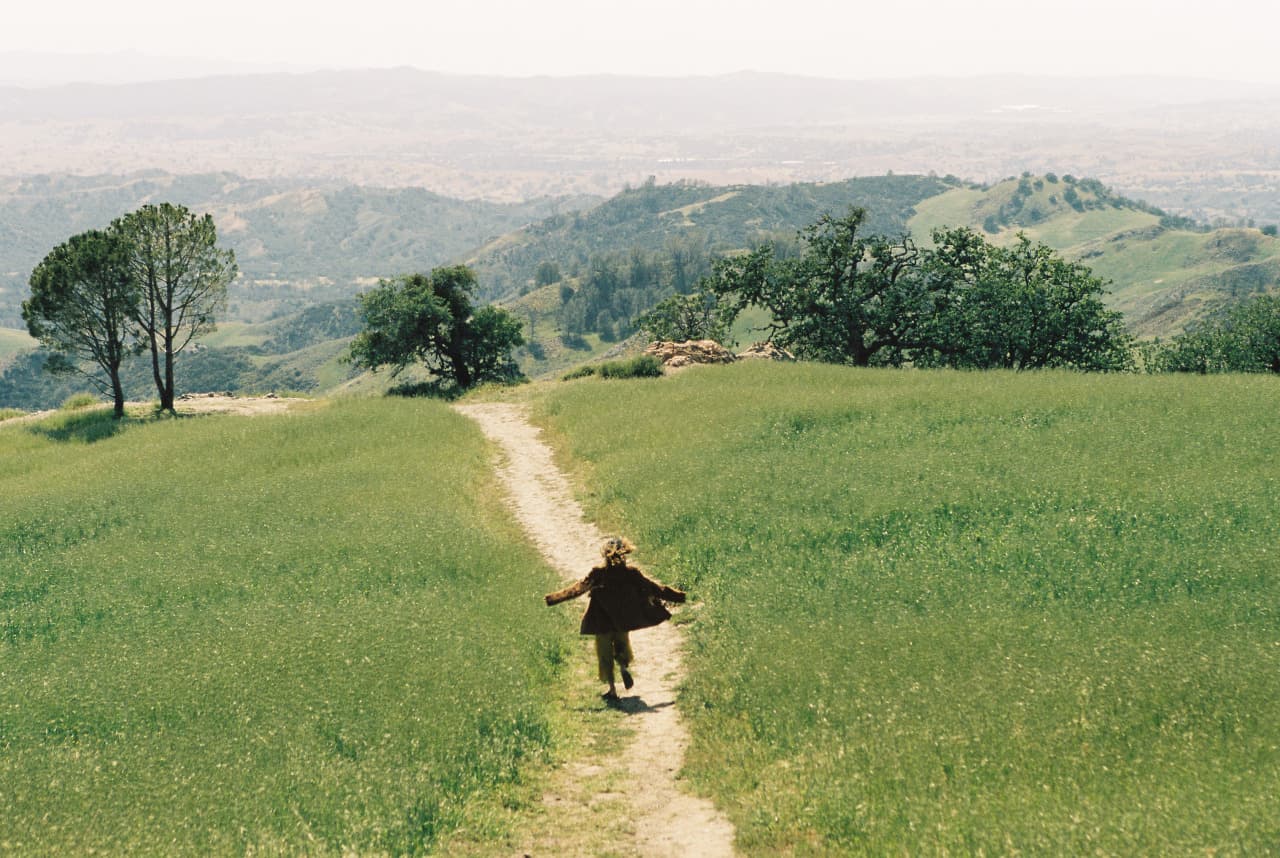Woman strolling along hilltop path